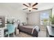 Bedroom featuring a ceiling fan, vanity, and natural light from a large window at 5410 Amaryllis Garden St, Apollo Beach, FL 33572