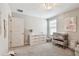 Bright Bedroom with a dresser and changing table, provides a functional and organized space for baby care at 5410 Amaryllis Garden St, Apollo Beach, FL 33572