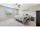 Bedroom features a ceiling fan, carpet flooring, and a large window for natural light at 5410 Amaryllis Garden St, Apollo Beach, FL 33572