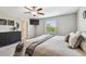 Bright bedroom features a ceiling fan, carpet flooring, and a large window for natural light at 5410 Amaryllis Garden St, Apollo Beach, FL 33572