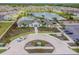 Aerial view of community clubhouse, pool, landscaping, and a circular driveway at 5410 Amaryllis Garden St, Apollo Beach, FL 33572