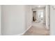 Hallway showing access to the bathroom with walk-in shower and vanity at 5410 Amaryllis Garden St, Apollo Beach, FL 33572