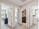 Hallway featuring doorways to various rooms, enhancing flow and access throughout the home at 5410 Amaryllis Garden St, Apollo Beach, FL 33572