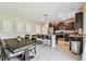 Bright kitchen and dining area featuring stainless steel appliances and dark wood cabinetry at 5410 Amaryllis Garden St, Apollo Beach, FL 33572