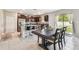 Open-concept kitchen with stainless steel appliances, granite countertops, and dining area at 5410 Amaryllis Garden St, Apollo Beach, FL 33572