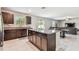 The kitchen island with granite countertops overlooks the living and dining area, with backyard access at 5410 Amaryllis Garden St, Apollo Beach, FL 33572