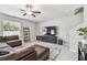 Inviting living room with tile floors, ceiling fan, large TV, and comfortable sectional sofa at 5410 Amaryllis Garden St, Apollo Beach, FL 33572
