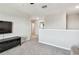 Bright living room area features neutral walls, plush carpeting, and a view of the hallway at 5410 Amaryllis Garden St, Apollo Beach, FL 33572