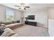 Cozy living room with neutral walls, plush carpeting, and a large window offering natural light at 5410 Amaryllis Garden St, Apollo Beach, FL 33572