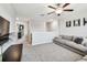 Comfortable living room features neutral walls, plush carpeting, and a cozy seating area at 5410 Amaryllis Garden St, Apollo Beach, FL 33572