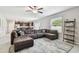 Spacious living room area with comfortable sectional, tile floors, and natural light at 5410 Amaryllis Garden St, Apollo Beach, FL 33572