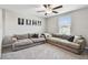 A sitting room has two sofas, light gray carpeting, neutral walls, and a window with blinds for natural light at 5410 Amaryllis Garden St, Apollo Beach, FL 33572