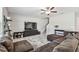 Inviting living room featuring a comfortable sectional sofa, ceiling fan, and large TV at 5410 Amaryllis Garden St, Apollo Beach, FL 33572