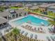 Aerial view featuring a luxurious community pool, outdoor seating, and a poolside bar area at 5410 Amaryllis Garden St, Apollo Beach, FL 33572