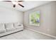 Room showcasing tile floors, natural light through a window, and a comfortable sofa at 5410 Amaryllis Garden St, Apollo Beach, FL 33572