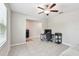 Open and airy room showcasing tile floors, ceiling fan, and connectivity to other living spaces at 5410 Amaryllis Garden St, Apollo Beach, FL 33572