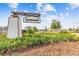 Welcoming entrance sign for Lynwood, set against a backdrop of lush greenery and glimpses of the charming neighborhood beyond at 5410 Amaryllis Garden St, Apollo Beach, FL 33572