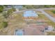 Single-story home with metal roof, screened in back porch and a spacious yard with chain link fence at 5432 Queen Ave, Spring Hill, FL 34609