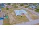 Single-story home with metal roof, a chain link fence, and a spacious yard on a corner lot at 5432 Queen Ave, Spring Hill, FL 34609
