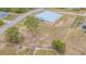 Single-story home with metal roof, screened back porch, chain link fence and spacious yard on a corner lot at 5432 Queen Ave, Spring Hill, FL 34609