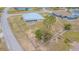 Large single-story home with a metal roof, screened in back porch, chain link fence and spacious yard at 5432 Queen Ave, Spring Hill, FL 34609
