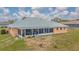 Backyard with a spacious screened lanai, metal roof, and peach-colored exterior at 5432 Queen Ave, Spring Hill, FL 34609