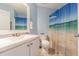 Bathroom with stylish white vanity and shower curtain featuring a beach scene at 5432 Queen Ave, Spring Hill, FL 34609