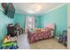 Cozy bedroom with tile floors, and a large window with light filtering curtains at 5432 Queen Ave, Spring Hill, FL 34609