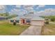Beautiful single-story home with a metal roof, double door entry, and an attached two car garage at 5432 Queen Ave, Spring Hill, FL 34609