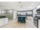 Open kitchen with granite countertops, white cabinets, and stainless steel appliances at 5432 Queen Ave, Spring Hill, FL 34609