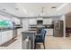 Well-lit kitchen featuring a center island, granite countertops, and stainless steel appliances at 5432 Queen Ave, Spring Hill, FL 34609
