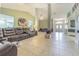 Expansive living room with tile floors, neutral walls, and views of the front entryway at 5432 Queen Ave, Spring Hill, FL 34609