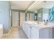 Well-lit main bathroom with double sink vanity and tile floors at 5432 Queen Ave, Spring Hill, FL 34609
