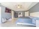 Spacious main bedroom featuring neutral walls, tile floor, tray ceiling and ceiling fan at 5432 Queen Ave, Spring Hill, FL 34609
