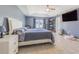 Spacious main bedroom featuring neutral walls, tile floor, tray ceiling and ceiling fan at 5432 Queen Ave, Spring Hill, FL 34609