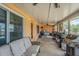 Enclosed patio with ceiling fans, and an arrangement of grills and cooking equipment at 5432 Queen Ave, Spring Hill, FL 34609