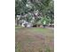 Spacious front yard featuring mature trees, a charming home with mature landscaping at 5535 Peach Ave, Seffner, FL 33584