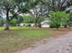 Quaint single-story home with mature trees, a spacious yard, and lush landscaping at 5535 Peach Ave, Seffner, FL 33584