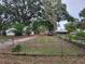 Spacious front yard featuring mature trees and a charming home with a detached garage at 5535 Peach Ave, Seffner, FL 33584