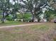 Charming single-story home with a detached garage and large trees in the front yard at 5535 Peach Ave, Seffner, FL 33584