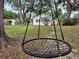 Unique hanging net yard swing and partial view of the home's exterior at 5535 Peach Ave, Seffner, FL 33584