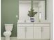 Modern bathroom with a double sink vanity, granite countertops, and a neutral color scheme, offering a serene and functional space at 6508 Propel Run, New Port Richey, FL 34655