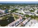 Overhead view of the condo complex, set amidst trees, and a pond with fountain feature at 8181 Eagles Park N Dr, St Petersburg, FL 33709