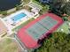 An aerial view showcases the community pool, tennis courts, and shuffleboard courts at 8181 Eagles Park N Dr, St Petersburg, FL 33709