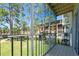Screened-in balcony view of the manicured lawn and community lake at 8181 Eagles Park N Dr, St Petersburg, FL 33709