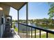 Screened-in balcony view of a serene lake with a fountain, surrounded by walking trails and mature trees at 8181 Eagles Park N Dr, St Petersburg, FL 33709