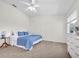 Bright bedroom with carpet, a ceiling fan, white walls, and a view of the outdoors at 8181 Eagles Park N Dr, St Petersburg, FL 33709