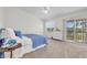 Bright bedroom with a balcony showcasing serene lake views and plush carpet flooring at 8181 Eagles Park N Dr, St Petersburg, FL 33709