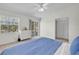 Bedroom with lake views through a sliding door and a large window for lots of natural light at 8181 Eagles Park N Dr, St Petersburg, FL 33709