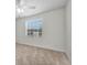 Bright bedroom featuring carpet, a window with blinds, and an electrical outlet at 8181 Eagles Park N Dr, St Petersburg, FL 33709